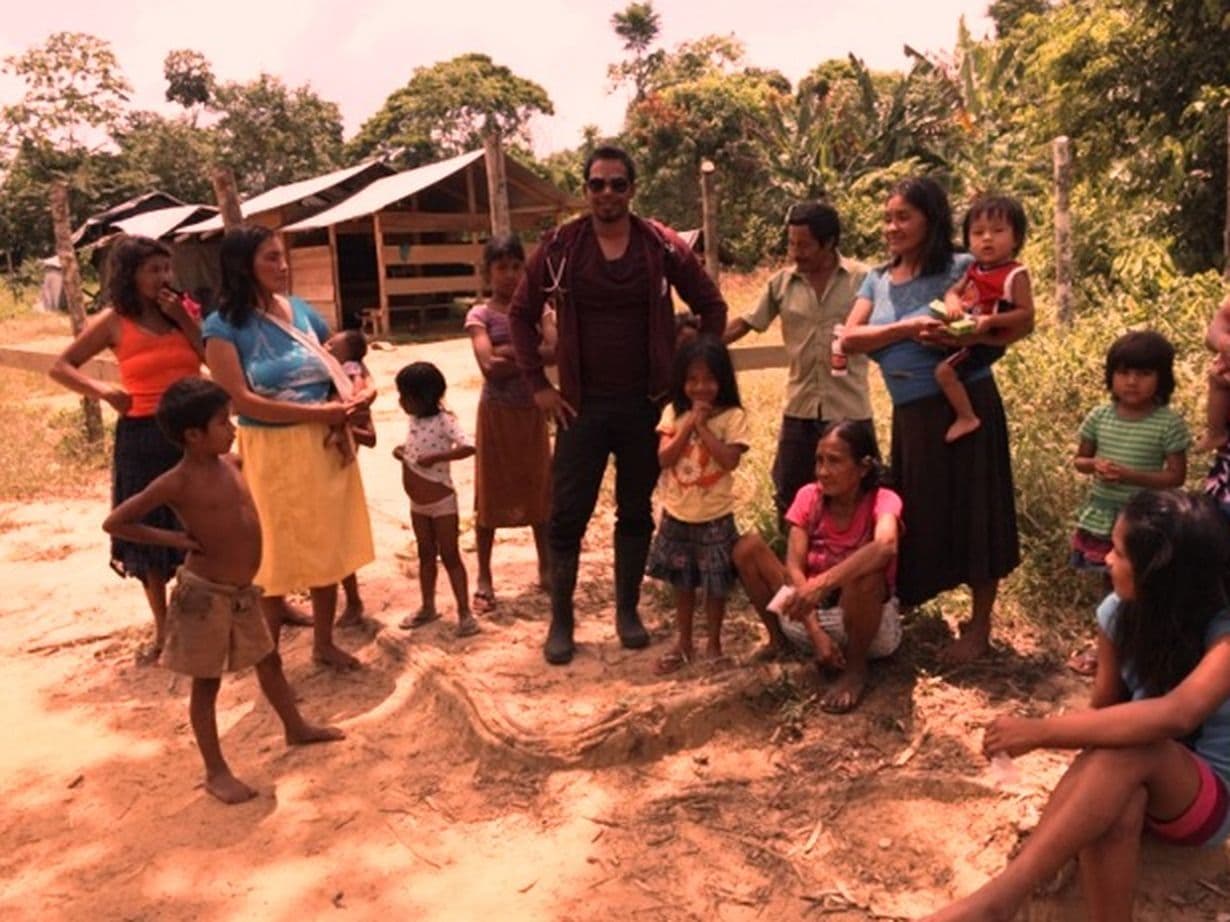 Dr. Antony with a family during a community outreach in Guyana